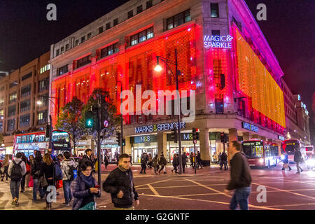 Massen von Weihnachtseinkäufern kommen zu Weihnachten in einer vollgepackten Oxford Street in London vor Marks & Spencers Flagship-Store im Londoner West End Stockfoto