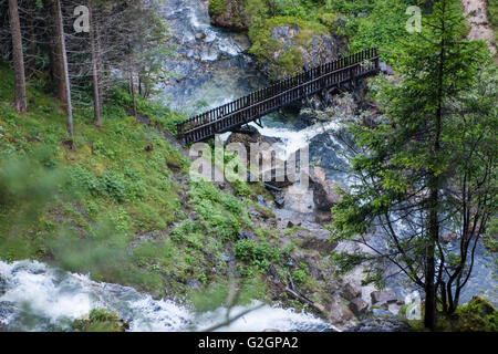 Wenig hölzernen Brücke in Berg, vorbei über einen Fluss. Ansicht von oben. Stockfoto