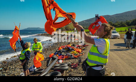 Lesbos, Griechenland - 13. Oktober 2015: Freiwillige winken Schwimmwesten für Flüchtlinge Stockfoto