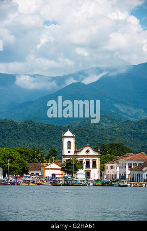 Ausflugsboote warten auf Touristen in der Nähe von der Kirche Igreja de Santa Rita de Cassia in Paraty Stockfoto