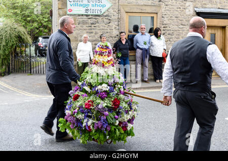 Castleton, Derbyshire, UK. 30. Mai 2016. Alten Garland Zeremonie obwohl die Straßen von Castleton im Peak District. Die Girlande "selbst ist ein Bienenstock förmigen Kopf-Kleid, mit Wildblumen und grün, die vom König über seinen Kopf und Schultern getragen wird. Die oberste, abnehmbare Stück die Girlande ist bekannt als "The Queen" und ist auch ein kleiner Bienenkorb-Form. Der Kranz oft wiegt zwischen 50 und 60 Pfund und ist sehr schwer, auf des Königs Schultern zu tragen. Bildnachweis: Ian Francis/Alamy Live-Nachrichten Stockfoto