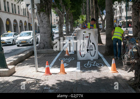 Städtische Arbeiter kennzeichnen ein Radweg. Fotografiert in Jaffa, Israel Stockfoto