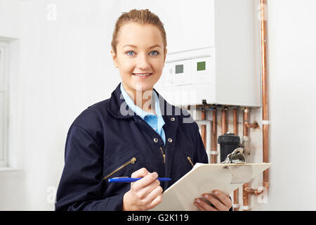 Weibliche Klempner Arbeiten an zentralen Heizkessel Stockfoto