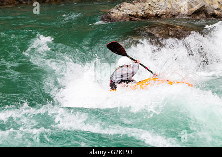 Ein Freestyle Kayaker navigiert die Stromschnellen auf dem Kananaskis River Kanu Wiesen-Kurs in Alberta. Stockfoto