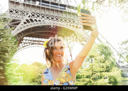 Paris, Frau tut ein Selbstporträt mit Eiffelturm auf Hintergrund Stockfoto