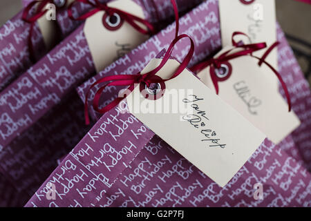 Violette Geschenktüten mit Namens-Tags auf Kinder-Geburtstagsparty Stockfoto