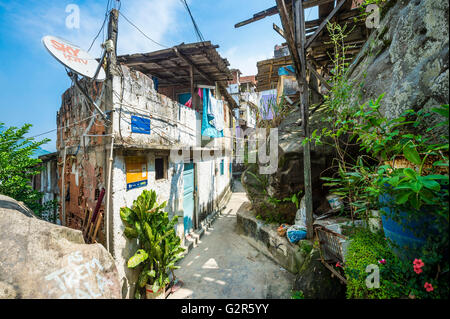 RIO DE JANEIRO - 31. März 2016: Sky-Satelliten-tv-Antenne befindet sich am Eckhaus auf einer engen Straße in der Favela Santa Marta Stockfoto