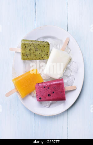 Eis Eis am Stiel aus Kiwi, gefrorenen Joghurt, Orange, Blueberry, Ansicht von oben Stockfoto