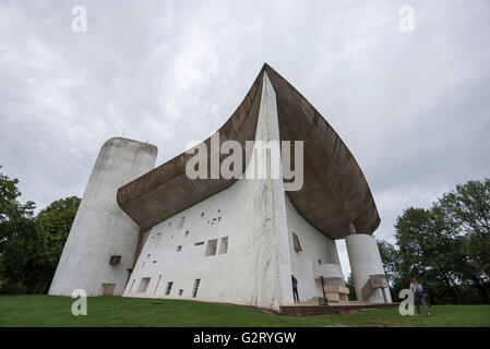 Die erstaunliche Kapelle von Notre Dame du Haut entworfen von dem berühmten Architekten Le Corbusier, Ronchamp, Frankreich, und Passanten ins Stockfoto