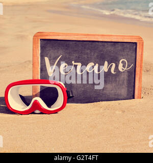 Nahaufnahme von einer Tafel mit einem Holzrahmen und das Wort Verano, Sommer in Spanisch geschrieben und eine Taucherbrille auf th gelegt Stockfoto