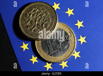 Eine 1-Euro-Münze und eine demjenigen Pfund-Münze auf dem Hintergrund der europäischen Flagge in London. PRESSEVERBAND Foto. Bild Datum: Donnerstag, 2. Juni 2016. Bildnachweis sollte lauten: Yui Mok/PA Wire Stockfoto