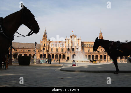 Spanien, Andalusien, Sevilla, Plaza de Espana mit Pferdekutschen zu mieten im Schatten im Vordergrund. Stockfoto