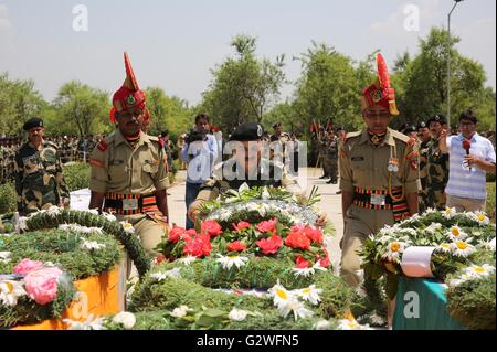 Srinagar, Kaschmir Indien kontrollierten. 4. Juni 2016. Ein Offizier von Indiens Border Security Force (BSF) legt einen Blumenkranz vor Särge der ermordeten Grenzsoldaten während einer Verlegung Kranzniederlegung in einem ASF-Camp am Stadtrand von Srinagar, Sommer in der Hauptstadt von Indien kontrollierten Kaschmir, 4. Juni 2016. Der militante Angriff auf Konvoi von Indiens Border Security Force (BSF) am Freitag hat drei Grenzsoldaten das Leben gekostet und neun weitere verletzt, zwei von ihnen schwer, in unruhigen Indien kontrollierten Kaschmir, sagten Beamte. Bildnachweis: Javed Dar/Xinhua/Alamy Live-Nachrichten Stockfoto