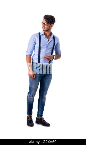 Porträt von Brünette junge Mann in Jeans, hellblaues Hemd und Hosenträgern, isoliert stehende im Studio gedreht gegen weiße Hinterg Stockfoto