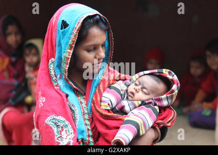 eine Mutter mit ihrem Neugeborenen Baby in einem Stammes-Dorf in Raiganj, Westbengalen Stockfoto