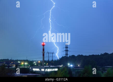 Blitze in der Nacht Himmel über das Kesselhaus und Stromleitungen Stockfoto