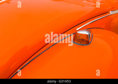 Detail des Flügels und Motorhaube eines Autos 1973 orange VW Käfer. Stockfoto