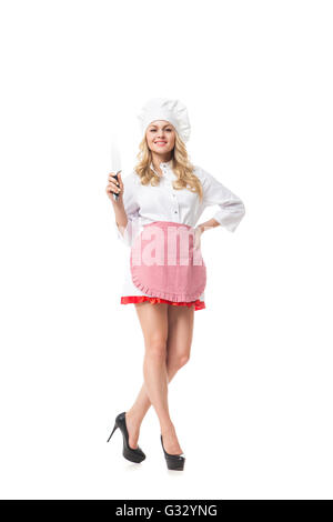 Porträt der schönen lächelnde Frau in Uniform mit Messer. Isolated.Studio Schuss Stockfoto