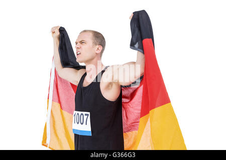 Athlet posiert mit deutscher Flagge nach Sieg Stockfoto