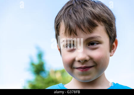 Ein Portrait eines lächelnden jungen vor einem blauen Himmel. Stockfoto