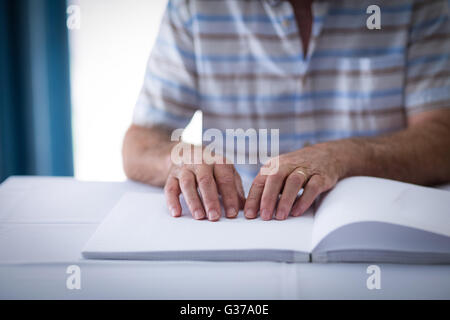 Blinder Mann ein Braille-Buch lesen Stockfoto