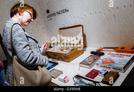 Lübeck, Deutschland. 10. Juni 2016. Ein Besucher, der Blick auf eine Ausstellung von Studenten, die Besuchern erlaubt, Objekte wählen notwendig für einen Flug auf der Messe gemacht "Fremde Heimat. Flucht Und Exil der Familie Mann "(lit.) "Fremde Heimat. Flucht und Exil der Familie Mann ") in Lübeck, Deutschland, 10. Juni 2016. Die Ausstellung im Buddenbrookhaus ist von 12. Juni 2016 bis 8. Januar 2017 geöffnet. Foto: MARKUS SCHOLZ/Dpa/Alamy Live News Stockfoto