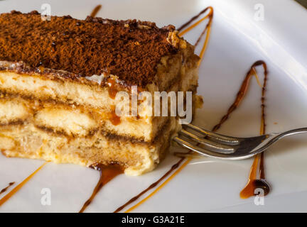 ein großes Stück der traditionellen italienischen, unvergesslich lecker, reich und süß Tiramisu-Torte mit Zimt, Karamell, Honig ein Stockfoto