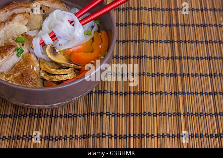 Die gedünsteten Nudeln mit Ente auf Bambus-Hintergrund Stockfoto