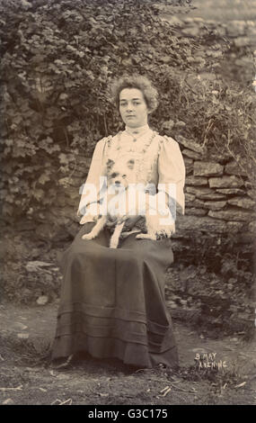 Junge Frau mit Terrier in einem Garten Stockfoto