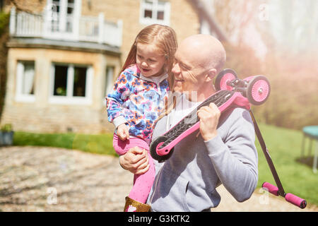 Vater mit Tochter und scooter Stockfoto