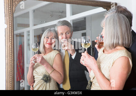 Paar verkleidet und Drink vor Spiegel Stockfoto