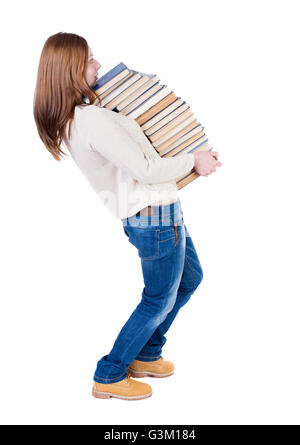 Eine Mädchen trägt einen schweren Stapel Bücher. hinten Sie Ansicht von. Hintere Ansicht Menschen Sammlung. Rückseite Blick auf Person. Isoliert auf weißem Hintergrund. Stockfoto