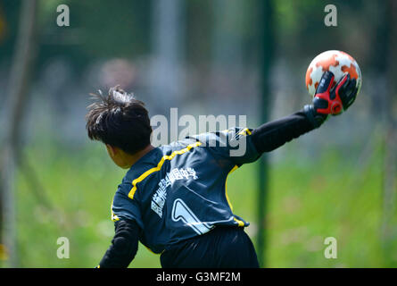 Enshi, Chinas Provinz Hubei. 13. Juni 2016. Torwart tritt während einer lokalen juvenile Fußballliga in Enshi Tujia und Miao autonome Präfektur, Zentral-China Hubei Provinz, 13. Juni 2016. Die Regierung von Enshi, befindet sich in der westlichen bergigen Gegend von Hubei, hat viele Anstrengungen gemacht bei der Förderung der Fußball Spiel unter Jugendlichen in den letzten Jahren. © Song Wen/Xinhua/Alamy Live-Nachrichten Stockfoto