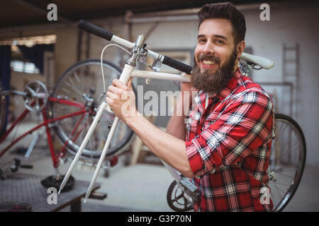 Porträt der Mechaniker mit dem Fahrrad in die Werkstatt Stockfoto