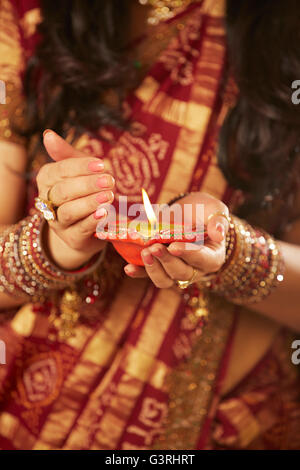 1 schöne erwachsene Frau Diwali Festival Diya Hände schalenförmig Windschutz Mittelteil Stockfoto