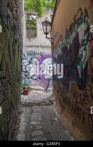 Einer der winzigen Gassen im historischen Stadtteil Anafiotika, Zentrum von Athen, bedeckt in der street Art und Graffiti. Stockfoto