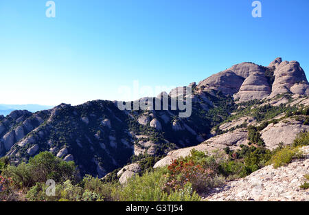Berge von Montserrat, Katalonien, Spanien, und kleine steinerne Kapelle von Sant Joan am Berghang Stockfoto