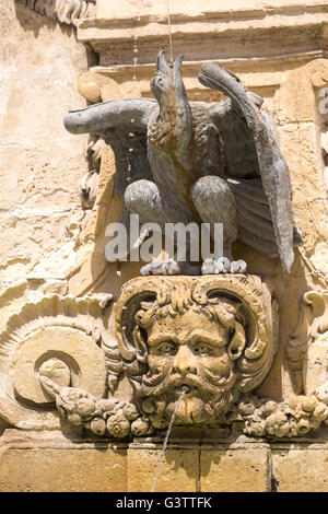 Wasser-Brunnen Malta.  Geschnitzte Gesicht auf einem Brunnen in St. George Square Stockfoto