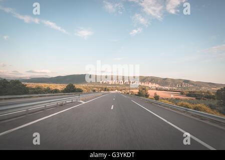 Befestigte zwei Lane Straße Kreuzung Berge und Wald. Panoramablick vom Auto montierten Kamera. Sommer-Abenteuer und Roadtrip in die Stockfoto