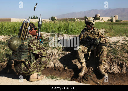 Soldat der US-Armee nimmt sich eine Auszeit mit einem Afghan National Army Soldaten. Stockfoto