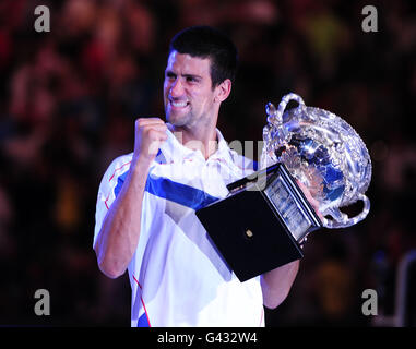 Tennis - 2011 Australian Open - Tag Vierzehn - Melbourne Park. Der serbische Novak Djokovic feiert mit der Trophäe Stockfoto