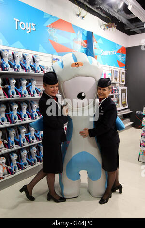 Die Botschafterinnen Sheila Beesley (rechts) und Helena Flynn von British Airways posieren mit dem Maskottchen Mandeville bei der Eröffnung des ersten offiziellen London 2012 Olympic Stores im Terminal 5 am Flughafen Heathrow. Stockfoto