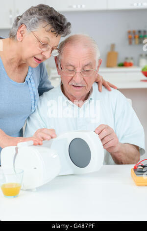 älteres Ehepaar mit Kaffeemaschine Stockfoto