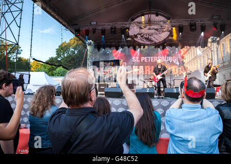 Zuschauer, die Dreharbeiten einer Konzert-Rock-Band auf Ihren mobilen Geräten Stockfoto