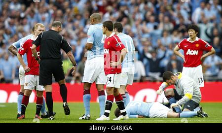 Schiedsrichter Mike Dean Gesten geben den Grund für die rot Karte, die Paul Scholes von Manchester United (links) nach dem Fouling gezeigt wurde Pablo Zabaleta von Manchester City (auf der Etage) Stockfoto