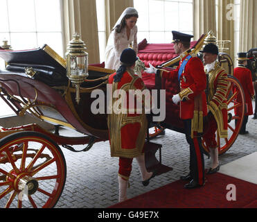 Der britische Prinz William (rechts) hilft seiner Braut Kate, den 1902 State Landau zu verlassen, als sie nach ihrer Hochzeit im Buckingham Palace im Zentrum Londons ankommt. Stockfoto