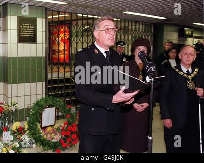 Alan Healey, Kaplan der Londoner Feuerwehr, erinnert vor einer Gedenktafel am Brandort an die 31 Menschen, die bei der Feuerkatastrophe am King's Cross vor 10 Jahren ums Leben kamen. Eine Schweigeminute um 19 Uhr in der U-Bahn der Hauptstadt folgte einem kurzen Service an der King's Cross Station, an dem Familien von Opfern der Tragödie, Mitglieder der Londoner Feuerwehr und der britischen Verkehrspolizei sowie Mitarbeiter der Londoner U-Bahn teilnahmen. Der Bürgermeister von Camden, Ray Adamson (rechts), legte einen Kranz vor die Gedenktafel. Siehe PA Story FIRE Memorial. PA-Fotos. Stockfoto