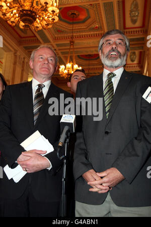 Sinn Fein-Präsident Gerry Adams, flankiert von Martin McGuinness, spricht in der großen Halle von Stormont, Belfast, mit den Medien, da Martin McGuinness als stellvertretender erster Minister gewählt werden sollte. Stockfoto