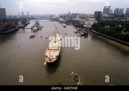 Die Royal Yacht Britannia im Pool von London, als die Queen während ihres Flußfortschritts von Greenwich nach Lambeth eine Mittagsfeier an Bord gab. Im Hintergrund ist HMS Belfast mit Minensuchboot HMS Croften daneben. Stockfoto