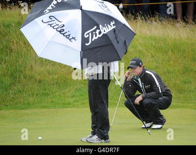 Der nordirische Rory McIlroy (rechts) führt einen Putt während der Open Championship 2011 bei Royal St George's, Sandwich an Stockfoto